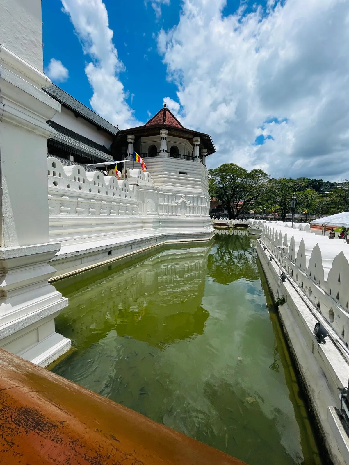 The white Temple of the Tooth in Kandy with its octagonal tower above the moat