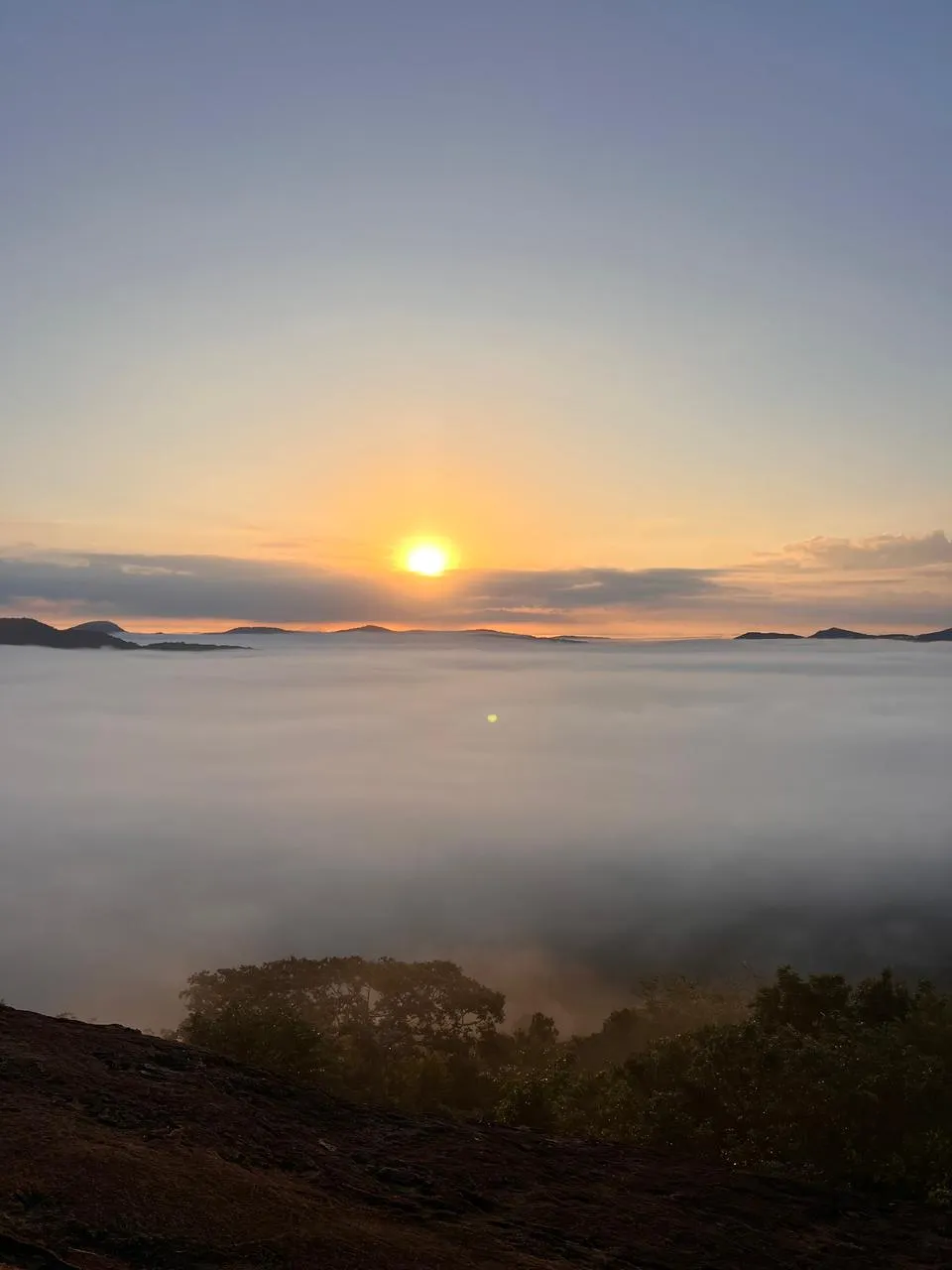Sunrise breaking over a sea of low cloud, seen from the summit of Pidurangala rock