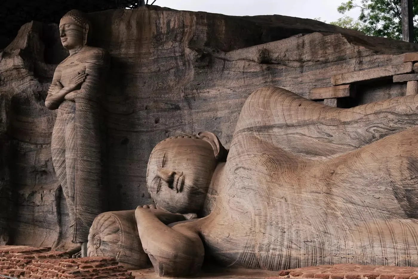 The reclining and standing Buddha statues carved from a single granite face at Gal Vihara
